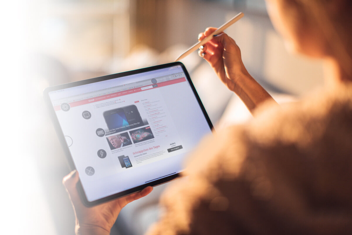 Woman working on a tablet with a pen Woman working on a tablet with a pen