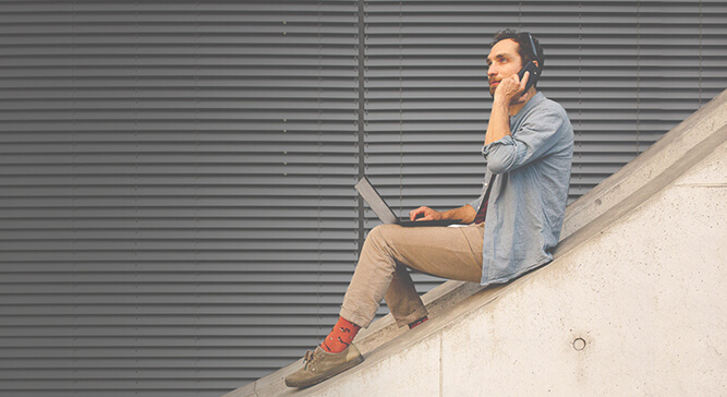 Man sitting outside with laptop